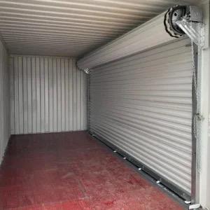 BLACK SHIPPING CONTAINER WITH ELECTRIFIED ROLL UP OPENING